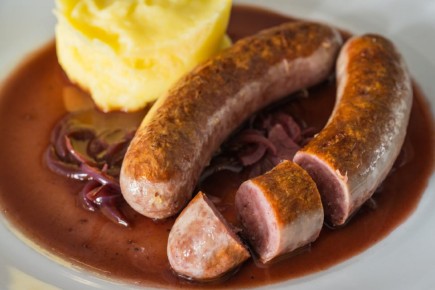 Необычные колбаски с винно-луковым соусом: новый вкус привычного блюда